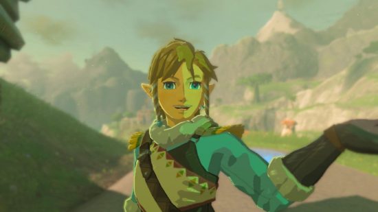Zelda Tears of the Kingdom shield surf - Link, a blonde boy in a feathery blue and white outfit looking cheerful against the backdrop of tall grey mountains.