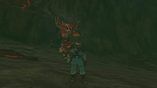 Zelda: Tears of the Kingdom weapons - Link, a blonde boy in ornate armour standing in front of a centaur creature called a Lynel in a dark cave.