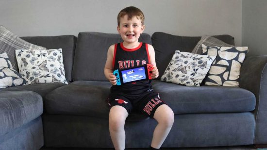 Miniclip Make A Wish partnership: Young boy Oliver holding a Nintendo Switch