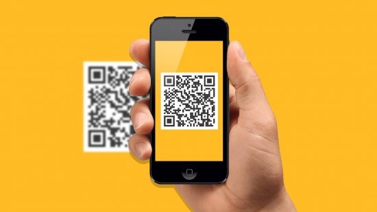 How to scan with iphone: a hand holds up an iphone, while the screen shows a QR code