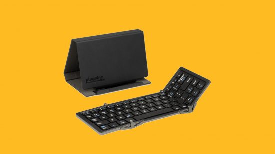 Best iPhone keyboard: The Plugable folding bluetooth keyboard and its accompanying stand in black, pasted on a mango background.