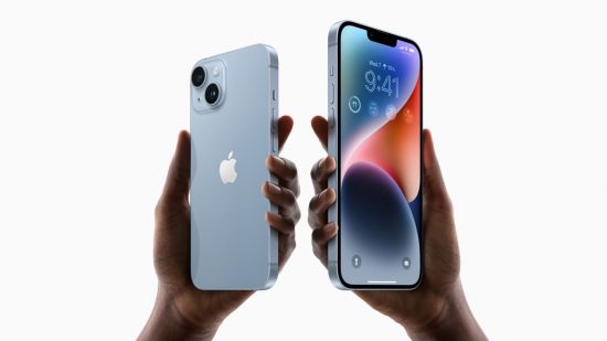 Best Verizon phone deals header showing two hands on a white background holding an iPhone 14 and iPhone 14 Plus aloft. On the right is the bigger one, the plus, in blue, facing forward, with a blue and red abstract background on its screen and widgets below the time at the top. On the left is the smaller one, also in blue, with back facing us. It has the Apple logo centred, and a square camera bump in the top left corner with two cameras diagonally opposite within the square.