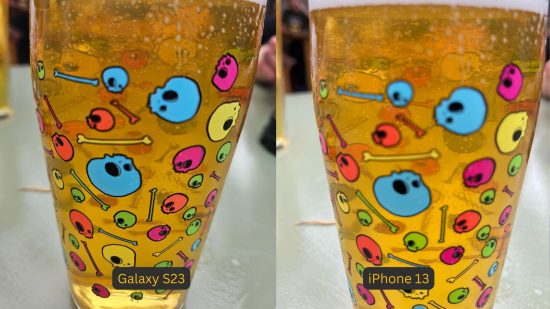 Samsung Galaxy S23 review photo comparison showing the S23 on the left and iPhone on the right, with identical pictures. They are both a closeup shot a a beer glass with beer in it and colourful skulls adorning the outside.