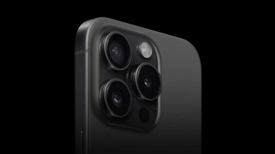 Apple event header showing the iPhone 15 Pro and its three cameras, all in black on a black background.