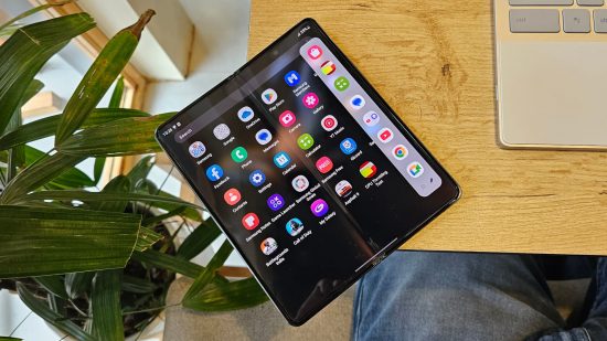 Samsung Galaxy Z Fold 4 Review - a photo of the phone unfolded on a table, displaying a large selection of apps
