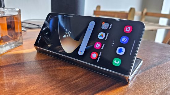 Samsung Galaxy Z Fold 4 Review - a photo of the phone half folded and sitting on a wooden table 