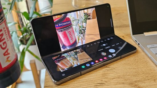 Samsung Galaxy Z Fold 4 Review - a photo of the phone folded at a 90 degree angle, showing the same phone and a few apps across the two screens