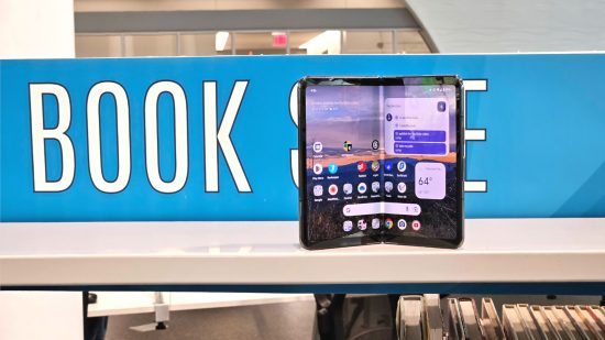 Google Pixel Fold review - the Pixel Fold standing in front of a book sign