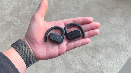 The JBL Soundgear Sense in the palm of someone's hand