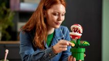 Lego Super Mario Piranha Plant: a women holds a Lego set based on a Piranha Plant