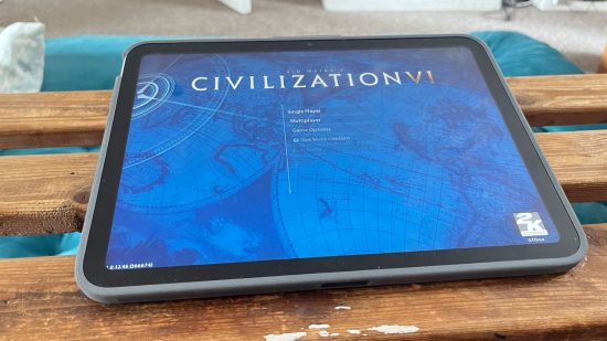 Logitech iPad keyboards header showing an iPad in a grey case lying nearly flat on a wooden bench showing the Home Screen of Civilization VI.