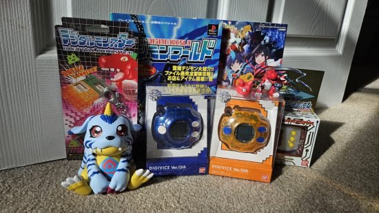 Digimon Go app - multiple Digivice toys and some Digimon memorabilia in the sun