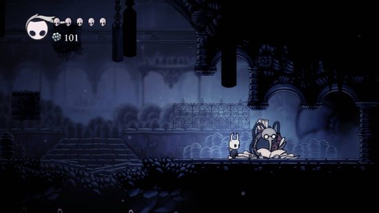 Hollow Knight review: The Knight stands next to a bug-like cartographer called Cornifer