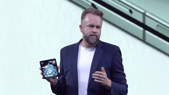 Screenshot from the OnePlus Open launch event with Tuomas Lampen showing off the phone on stage