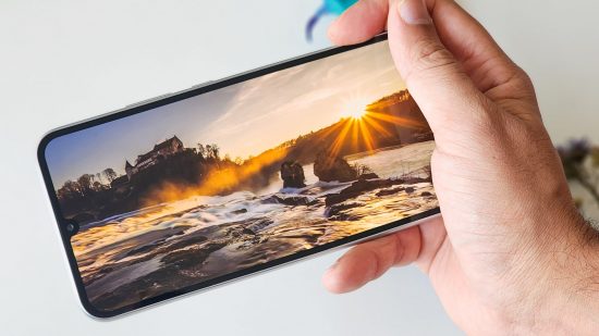 Picture of the display on the Samsung Galaxy A34 showing the sun setting over a lake for a review of the phone