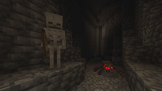 Minecraft mobs hostile - a skeleton and a spider inside a dark cave