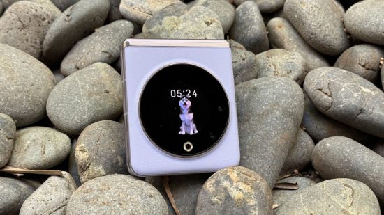 Custom image of the Tecno Phantom V Flip on a rocky beach for a review of the phone