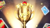 UNO Mobile Community Cup Final: A close-up of a golden UNO trophy with gold gards and a phone popping out the top