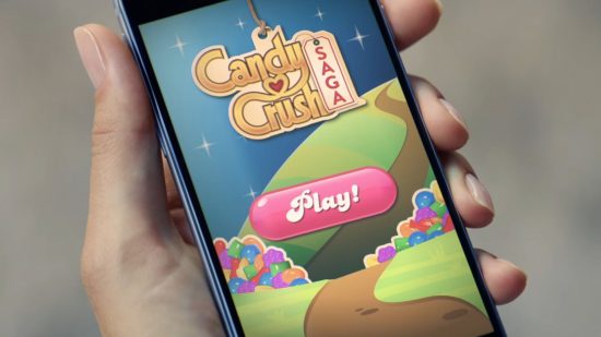 Screenshot from a Candy Crush advert with someone playing on their phone