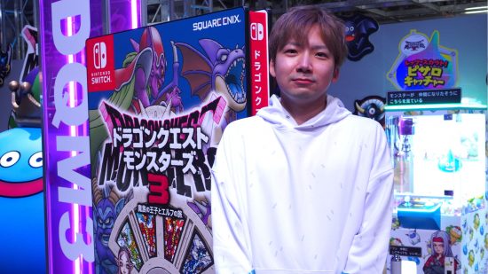Dragon Quest Monsters: The Dark Prince interview - a photograph of producer Kento Yokota standing at a Dragon Quest booth at an event