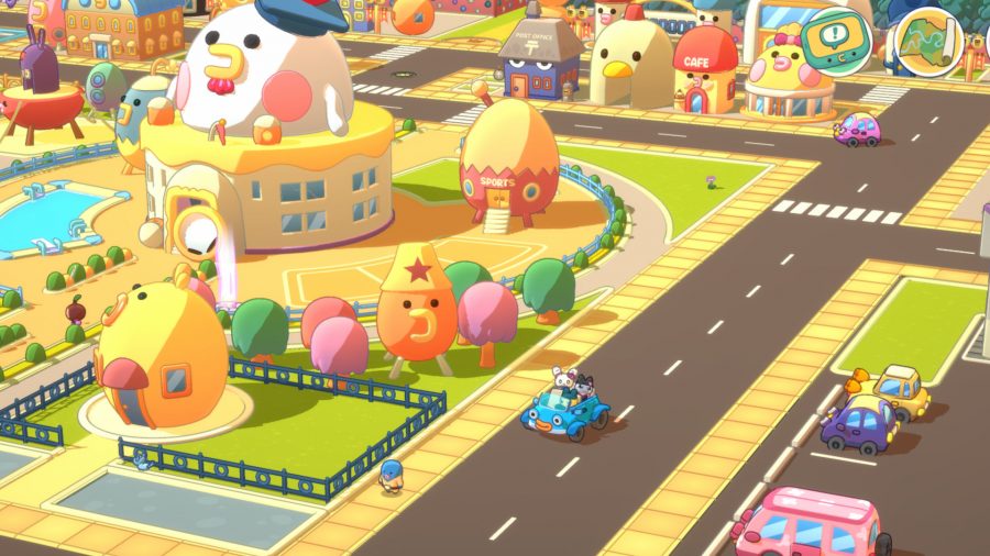 Tamagotchi Adventure Kingdom hero image featuring a screenshot of the city's many buildings including a car driving down a street with three Tamas inside