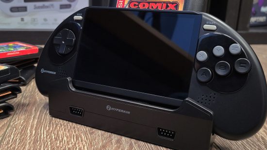Image of the prototype Mega 95, a handheld Sega Genesis and Mega Drive compatible console, in its dock