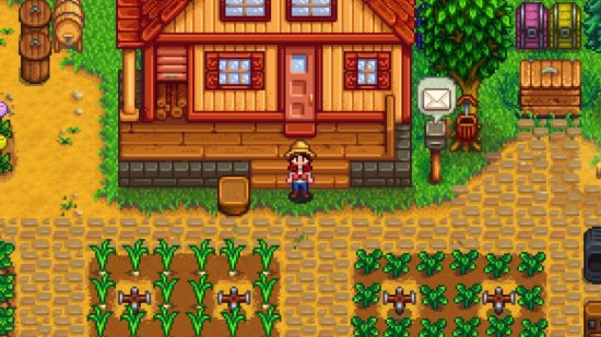 Stardew update - a farmer stood outside a house in front of some grown crops
