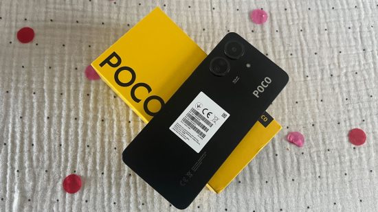Custom image of the Poco C65 next to its box on a plain background for a review of the phone