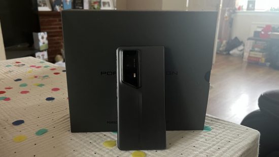 Custom image for Porsche Edition HONOR Magic V2 RSR review with the phone folded and leaning against its box