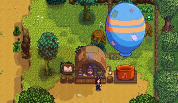 The Stardew Valley bookseller next to a hot air balloon in Pelican Town