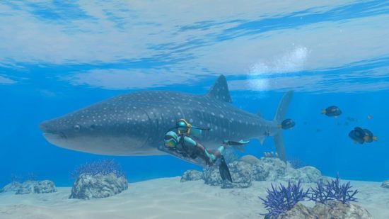 Endless Ocean Luminous review screenshot showing a scuba diver swimming next to a whale shark and blue tangs