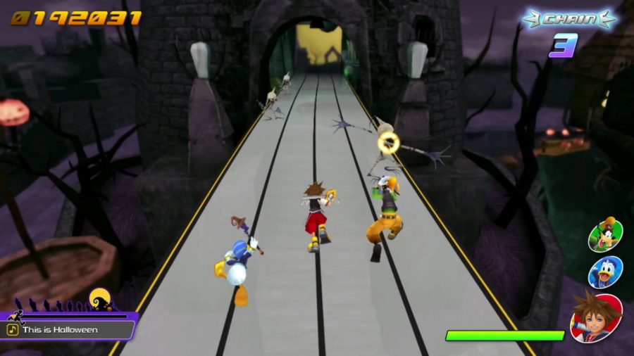 Sora, Donald, and Goofy are running on a track straight forwards. Enemies are approaching them, one with a yellow circle prompt on it, indicating that the player should press the button.