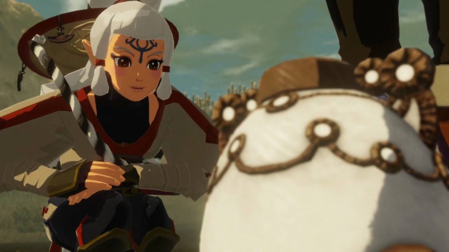 Impa looking quizzically at the miniature guardian while crouched down. Her hand is about to reach out to touch the white orb-shaped machine. 