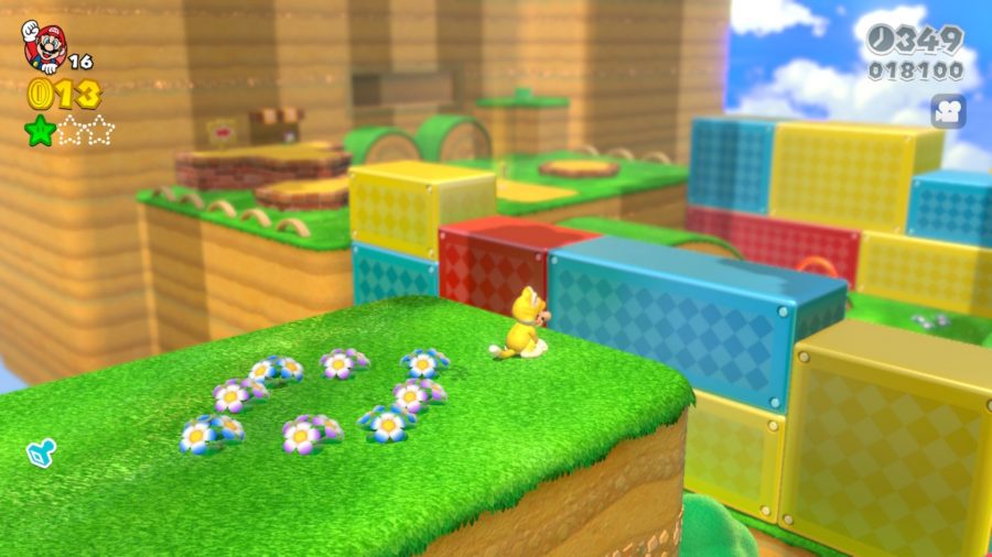 Cat Mario perching on a small hill overlooking a colourful level