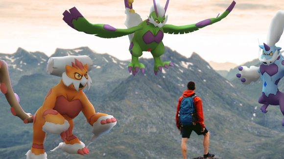 A player stands on a mountaintop facing three legendary Pokémon