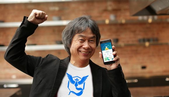 Miyamoto holds up an iPhone with Pokémon Go displayed