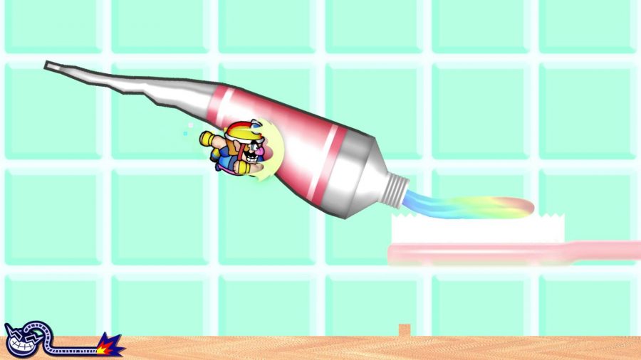 Wario is shoulder barging a giant tube of toothpaste, attempting to get some paste on a toothbrush