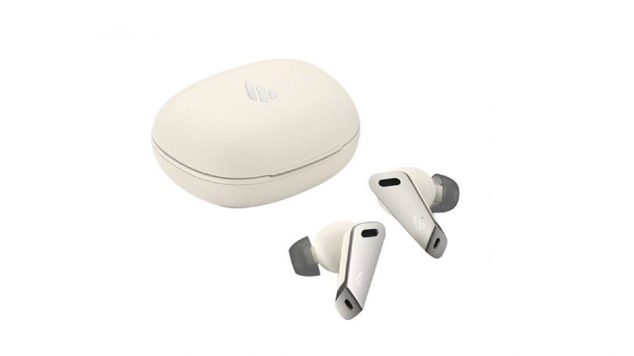 A pair of white and grey wireless earbuds are shown, sitting besides a white charging cradle