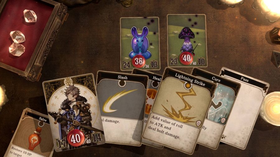 A tabletop game is being played, with several cards being shown with fantasy characters and enemies visible on them