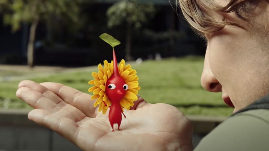 Pikmin Bloom coins; a Pikmin in a player's hand, with a flower behind its head