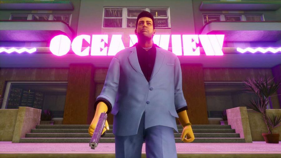 A character in a sharp blue suit walks away from a building with a bright pink neon sign