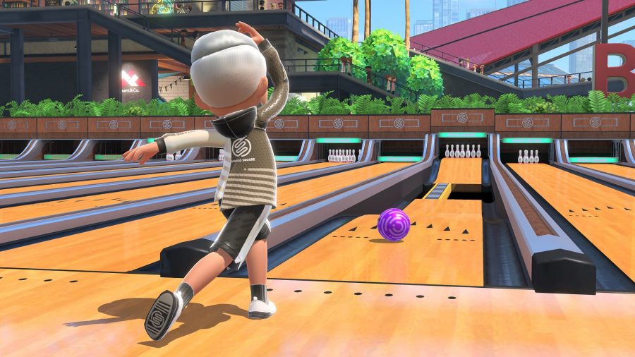 A player avater launches a bowling ball towards pins 