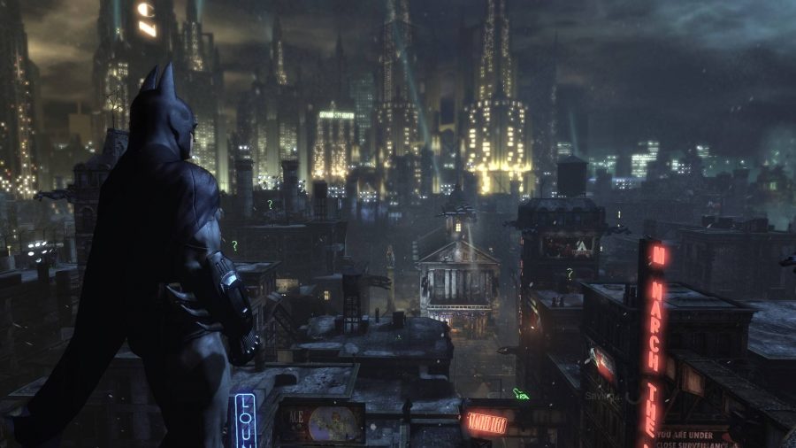 Batman stands looking over a city
