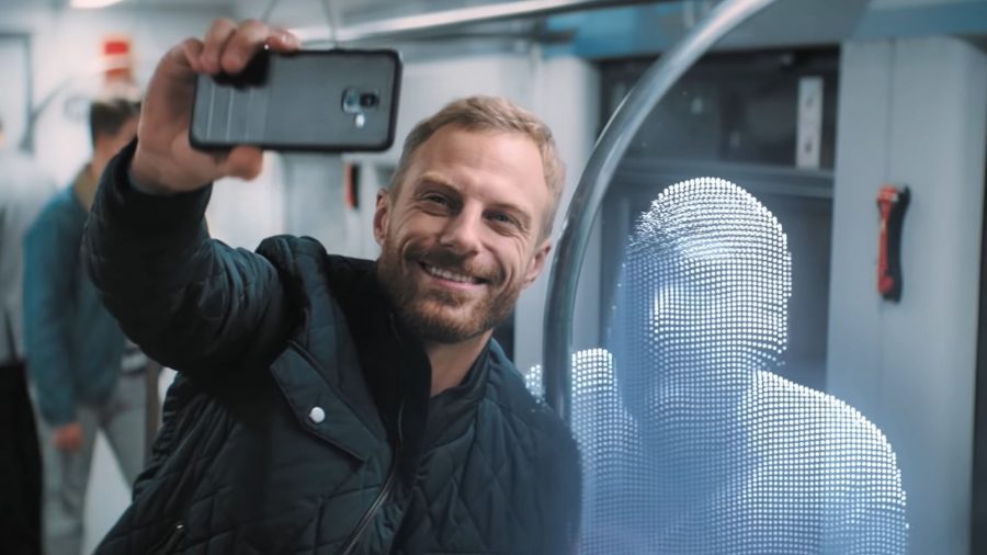 Taken from a NordVPN ad; a man taking a photo of himself with an encrypted figure on public transport