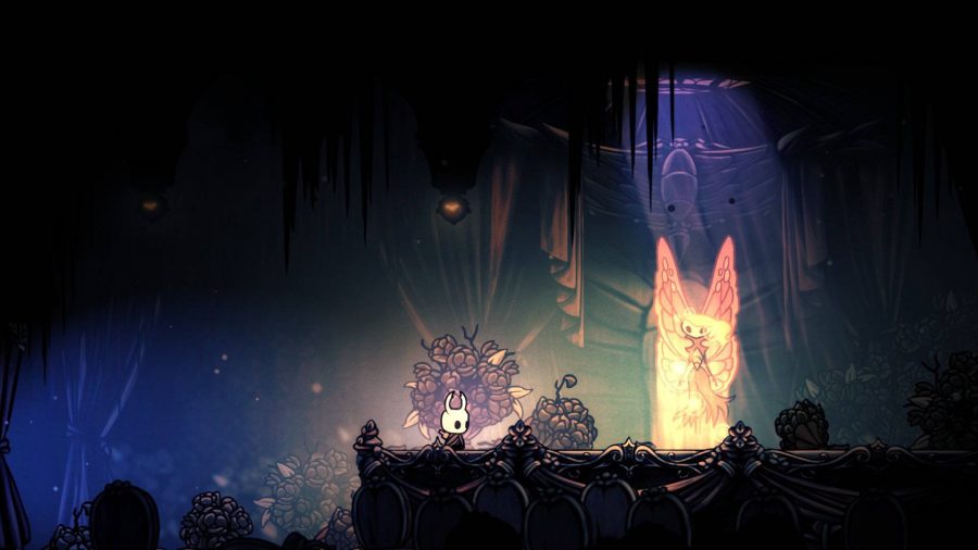 The Knight appears stood in front of a luminous moth-like character 