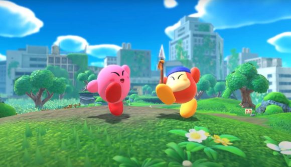 Kirby and Bandana Waddle Dee look triumphant atop a grass hill