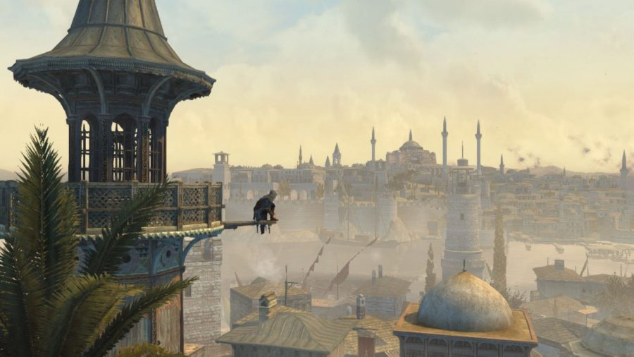A screenshot from Assassin's Creed: The Ezio Collection on Switch, showing Ezio atop a tall Turkish turret, overlooking Istanbul, with turrets and domes in the distance.