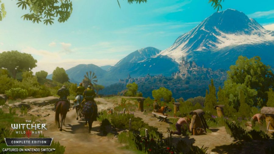 A screenshot from one of the best games like Zelda, The Witcher 3, showing Geralt and some pals riding their horses through the woods, with mountains in the distance.