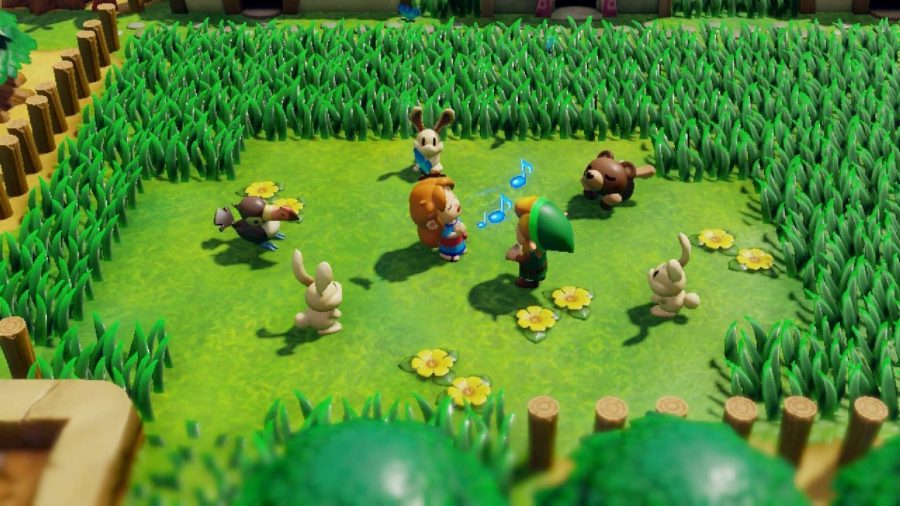 Link plays on an instrument in a grassy field 