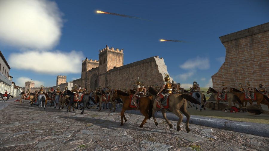 A screenshot from Rome Total War, showing mounted soldiers laying siege to a fort.